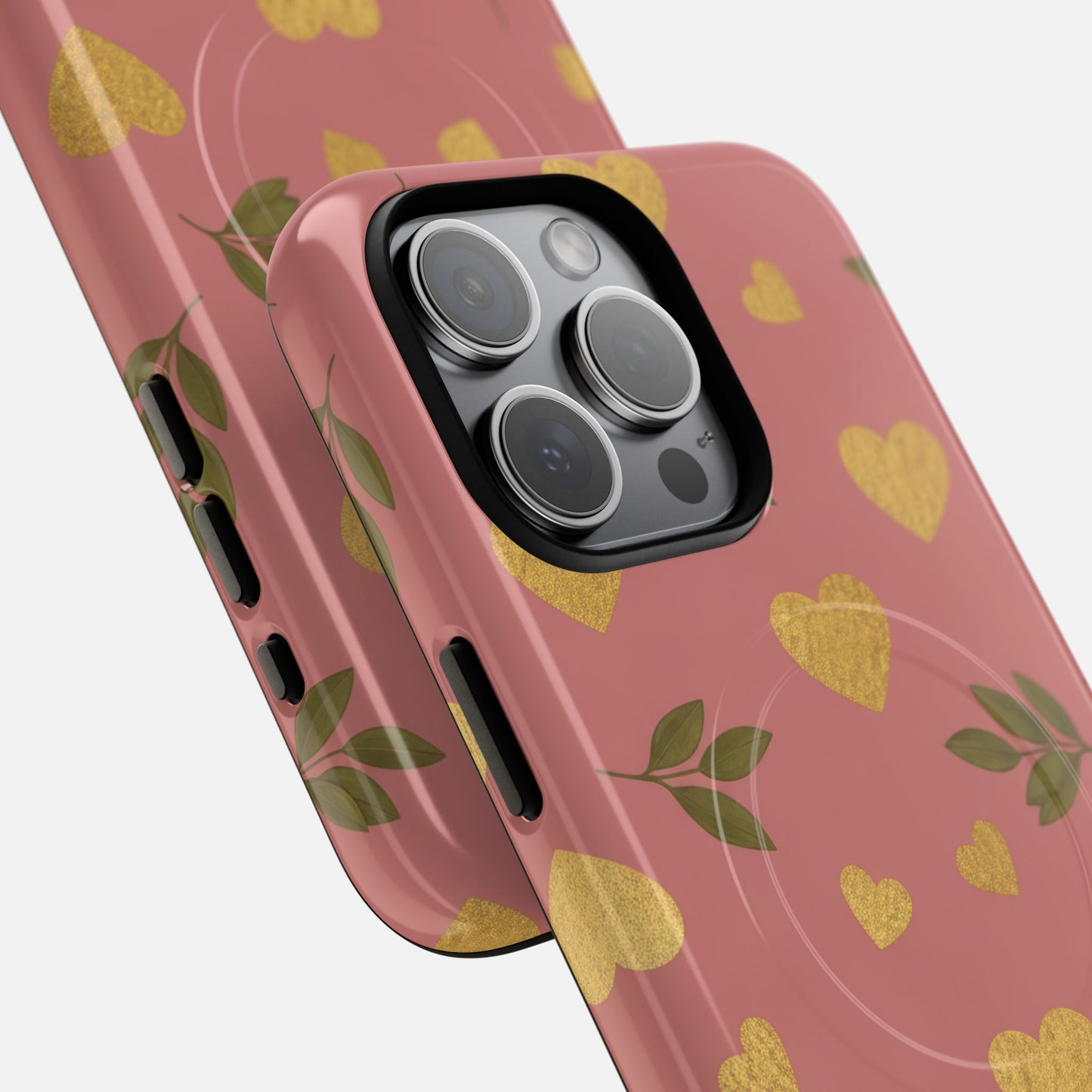 Pink phone case with gold hearts and green leaves, stylish design for iPhone camera protection