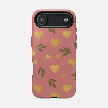 Pink phone case with gold glitter hearts and green leaves, stylish protective design for iPhone