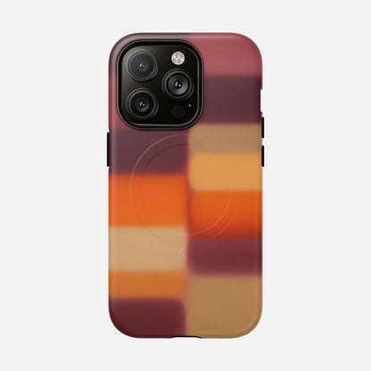 Phone case with gradient plaid design in warm red, orange, and tan tones for iPhone Pro