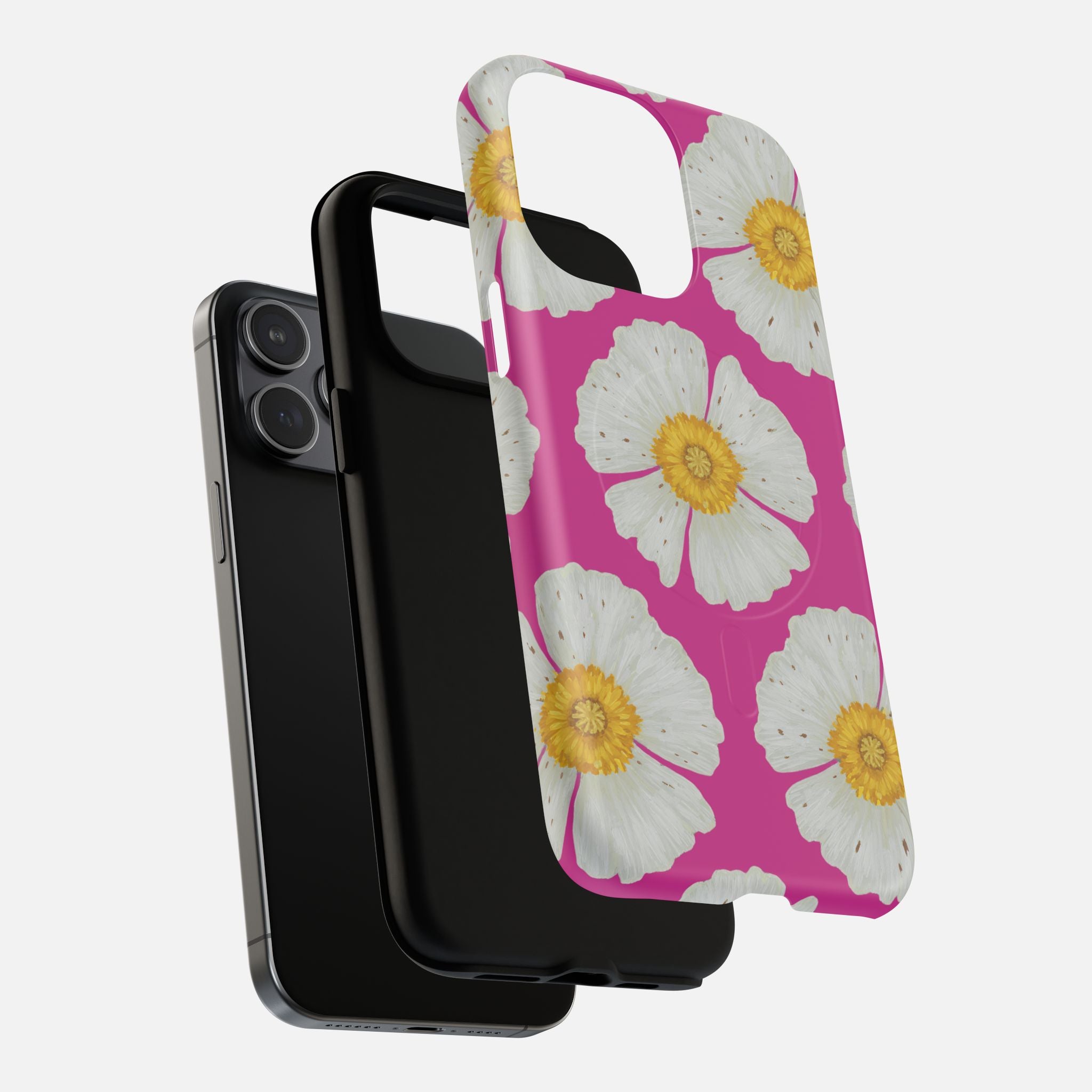 Pink phone case with white daisies and yellow centers, shown with black iPhone and case