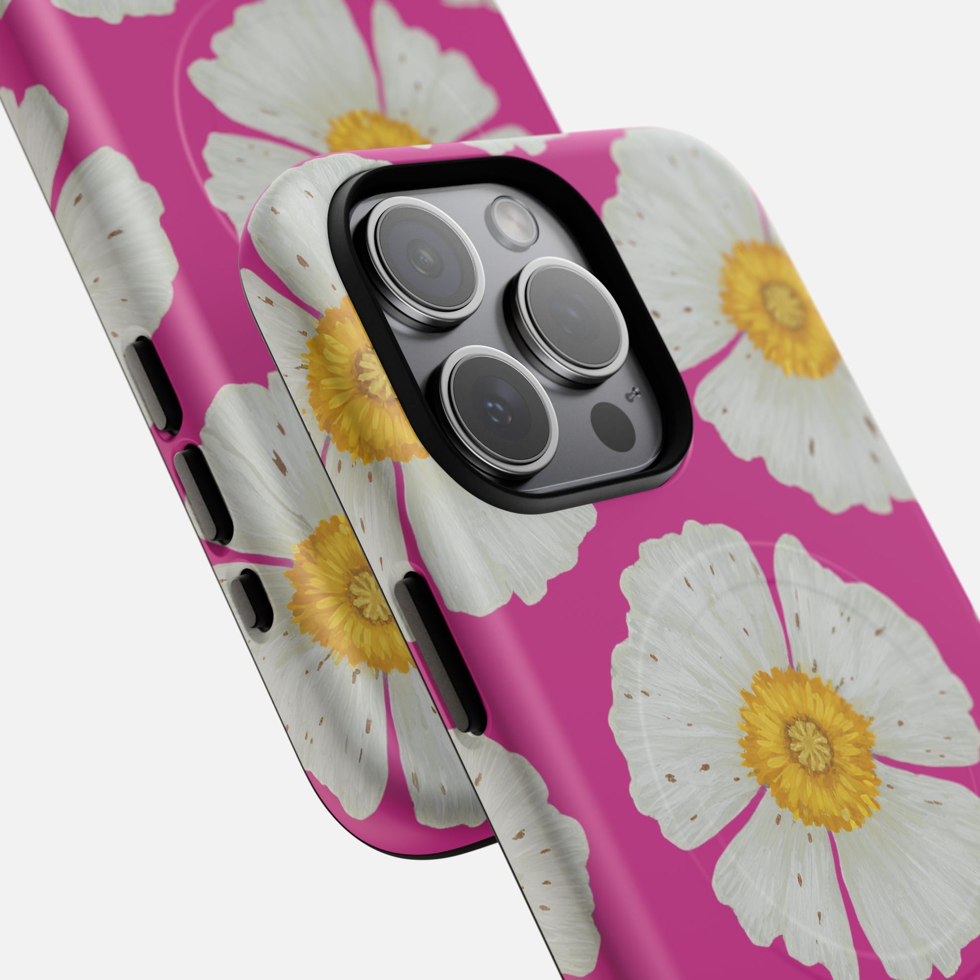 Pink phone case with white daisy flowers and yellow centers, designed for iPhone Pro camera cutout